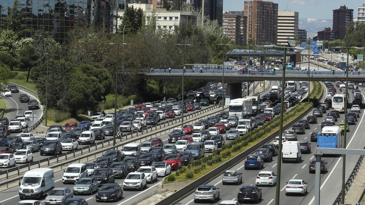 Heavy motorway traffic in a city with cars lined up in multiple lanes
