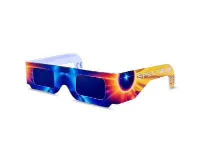 A single pair of Spectrum brand solar eclipse glasses featuring a vibrant sun and nebula design, ISO certified for safe celestial observation in Spain.